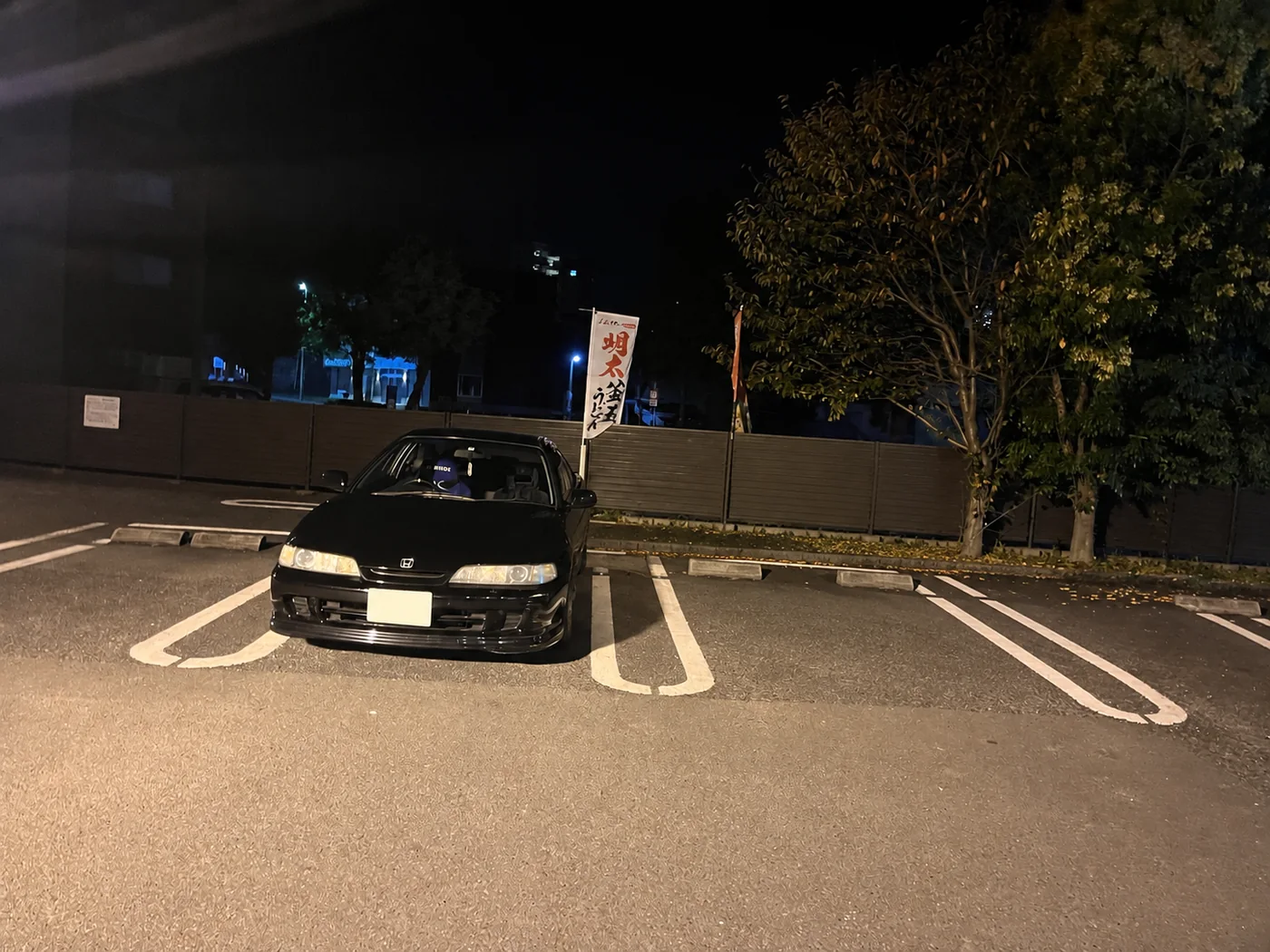 夜の駐車場に停めた黒いホンダ・インテグラ（DC2）の写真